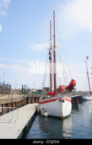 Peaceful moored yacht in Ballycastle Marina on a bright summer's day Stock Photo