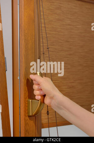 Arm open plastic window with blinds Stock Photo
