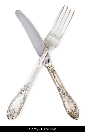 Old silver knife and fork crossed, isolated on white background Stock Photo