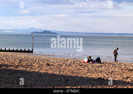 People relaxing on a beach, Portobello, coastal suburb of Edinburgh, Scotland, UK Stock Photo