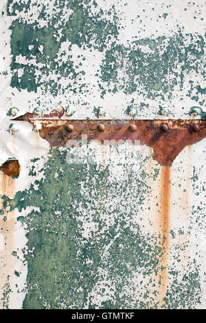 Peeling paint rust and rivets texture. Old metal garage door Stock Photo