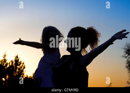 Backlighting. Mother with a child. Sunset. Pudent Lake. Formentera. Balearic Islands, Spain, Europe. Stock Photo