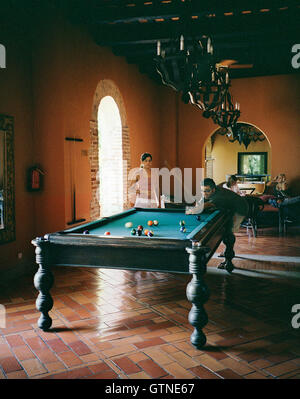 A young Dominican couple shoots pool while staying at the Sofitel Nicolas de Ovando Hotel in Santo Domingo. Santo Domingo Stock Photo