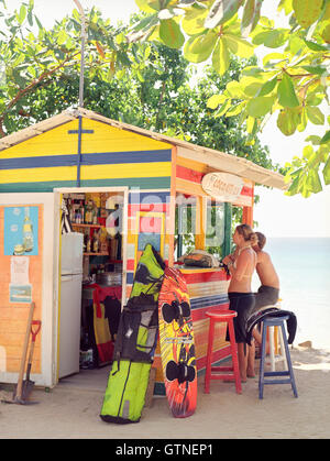 Tourists rent kite boards from the Coco Kite Club in the sea side village of Las Terrenas. Samana Penisula, Dominican Republic. Stock Photo