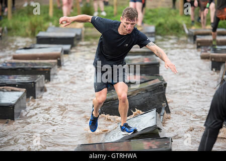 Cheshire, UK 10th September 2016. Participant completes the Island Hopping obstacle at Tough Mudder North West 2016 10/09/2016  Credit:  Gary Mather/Alamy Live News Stock Photo
