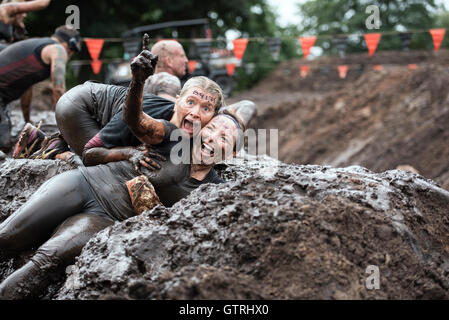 Cheshire, UK 10th September 2016.  Two ladies enjoying the mud at Tough Mudder North West 2016 10/09/2016  Credit:  Gary Mather/Alamy Live News Stock Photo