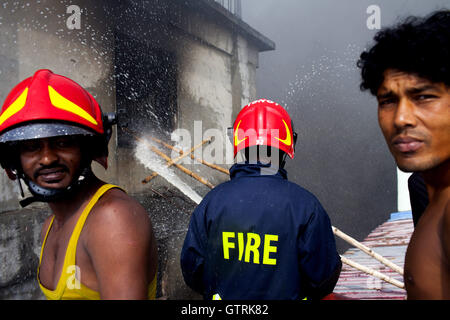 Bangladeshi firefighters work to douse a fire at the Bashundhara City ...
