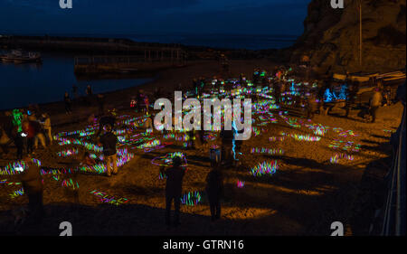 Staithes, UK. 10th September, 2016.  After dark, light artist Mick Stephenson and his team of volunteers planted 12,000 coloured glow-sticks on Staithes beach for his  Mighty Glow-Stick installation. The Staithes Festival of Arts and Heritage features a selling exhibition of artwork over the weekend  in temporary  galleries in cottages, houses and public spaces throughout the village. Photo Bailey-Cooper Photography/Alamy Live News Stock Photo
