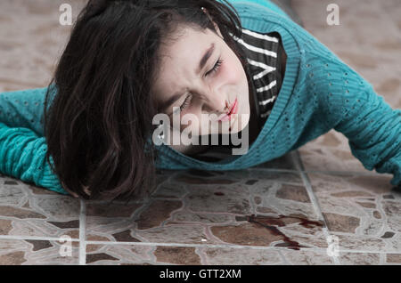 pretty young girl with a bleeding nose after falling down Stock Photo