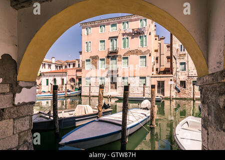 Chioggia glimpse from the arcades along the canals. Stock Photo