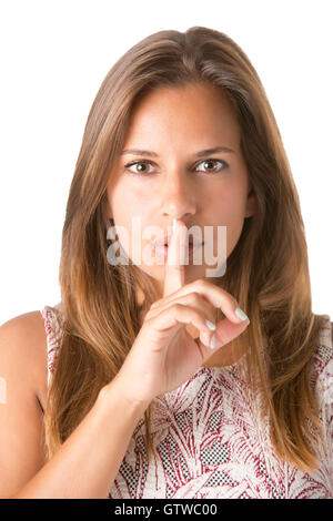 Closeup of a woman with her finger over her mouth, isolated in white Stock Photo
