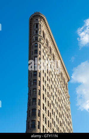 NEW YORK CITY - SEPTEMBER 5, 2016: The Flatiron Building, one of the first skyscrapers built with a steel frame, in blue sky. Stock Photo