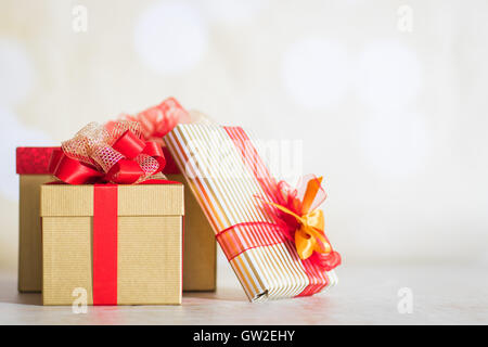 Christmas presents wrapped in a gold paper with red ribbons Stock Photo