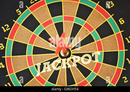 Word Jackpot written on the circular target with a plastic feather in the center Stock Photo