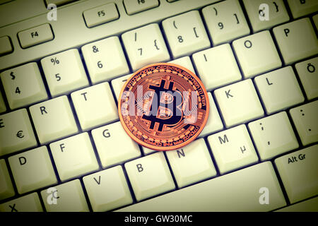 Bitcoin on computer keyboard, virtual currency Stock Photo