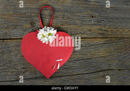 red wooden heart and daisy bouquet on rustic wood Stock Photo