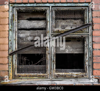 An old boarded up window on an abandoned building. Stock Photo
