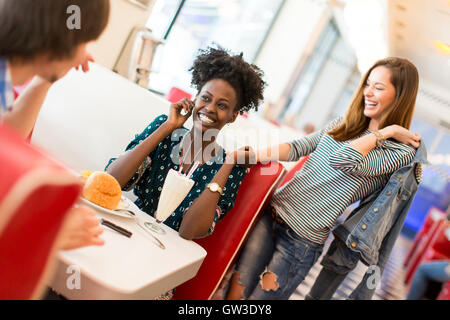 View of the friends eating in the diner Stock Photo