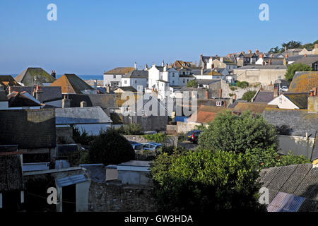 A view over the rooftops of Lyme Regis houses looking towards the sea and Cobb in Dorset with copyspace blue sky in England UK    KATHY DEWITT Stock Photo