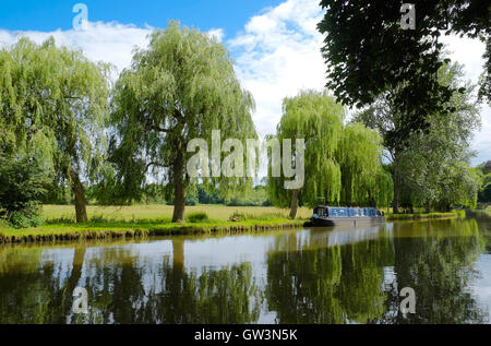 Distant view of a long boat on the River Wey near Guildford Stock Photo
