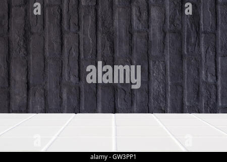 architectural background made of white ceramic mosaic floor and black brick wall Stock Photo