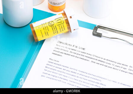 Prescription bottle with directions for use.  Labels and document are created by photographer. Stock Photo