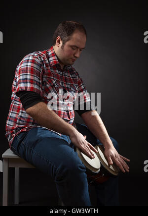 portrait of musician with bongo , studio shot Stock Photo