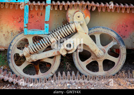 Close-up view of the wheels and chain of a rusty old military tank Stock Photo