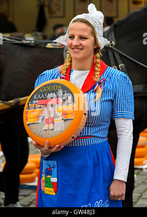 Dutch cheese girl with a Gouda cheese truckle, cheese market Gouda ...