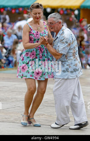 Festival couple enjoy dancing 1940s style - Lindy Hop / jive Stock Photo