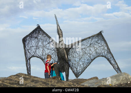 Staithes, North Yorkshire, UK, 10th September 2016. Weather: Children looking at pterodactyl sculpture by Emma Stothard on the harbour wall at Staithes Art festival.  During the weekend some 100  cottages in the picturesque Yorkshire fishing village become temporary art galleries as artists exhibit and sell paintings, prints, sculpture, jewellery... at Staithes Festival of Arts and Heritage. Staithes has long been a magnet for artists. Credit:  Alan Dawson News/Alamy Live News Stock Photo