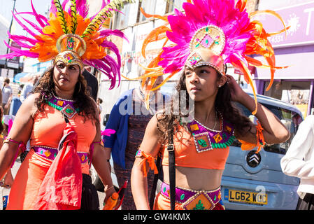 Hackney, London, UK. 11th September 2016. Two performers dressed up with flamboyant costumes walking during the Hackney Carnival 2016 in Ridley Road. Credit:  Nicola Ferrari/Alamy Live News. Stock Photo
