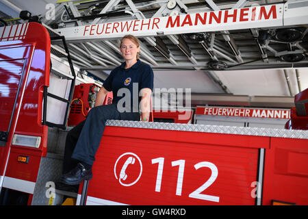 Mannheim, Germany. 24th Aug, 2016. Firewoman Lisa-Katharina Roeck sits on a fire engine at the southern fire station in Mannheim, Germany, 24 August 2016. Photo: Uwe Anspach/dpa/Alamy Live News Stock Photo