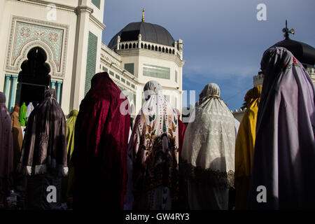 Medan, North Sumatra, Indonesia. 12th Sep, 2016. Indonesian Muslims attend prayers for Eid al-Adha prayers in a Mosque, in Medan, Indonesia, Sept, 12, 2016. Eid al-Adha is a holy of two Muslim holidays are celebrated every year, marking the largest annual Muslim pilgrimage (Hajj) to visit Mecca, the holiest site in Islam. Muslims slaughter sacrificial animals and divide the meat into three parts, one for family, one for friends and relatives, and one for the poor and needy. © Ivan Damanik/ZUMA Wire/Alamy Live News Stock Photo