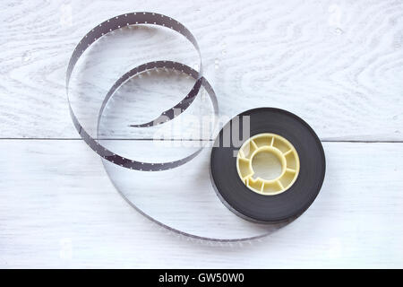 16mm film reel on white wooden background Stock Photo - Alamy
