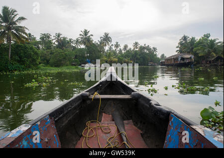 Travelling the back waters in a small traditional boat in Alappuzha (Alleppey), Kerala, Southern India Stock Photo