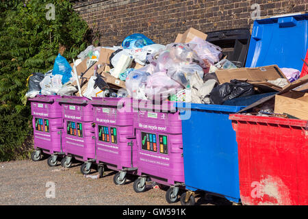 Overflowing mixed recycling bins in Limehouse, Tower Hamlets, London Stock Photo