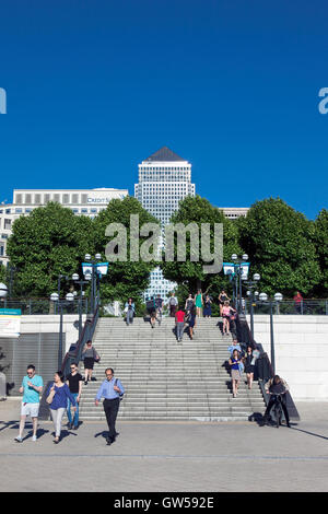 People walking up and down stairs in Westferry Circus, Canary Wharf with Canada One Square in the background, London, UK Stock Photo