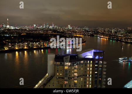 Night view of the River Thames with Cascades Tower in the foreground from Marsh Wall, Canary Wharf, London, UK, E14 Stock Photo