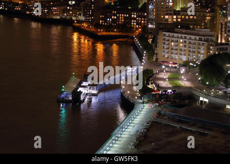 Night view of Canary Wharf Pier and the River Thames from Marsh Wall, Canary Wharf, London, UK, E14 Stock Photo