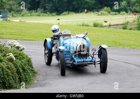 Mike Preston guides his 1926 Bugatti Type 35B into the roundabout at the 2016 Chateau Impney Hill Climb Stock Photo