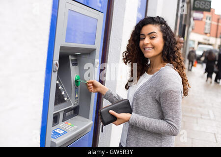 young woman at the cash machine Stock Photo