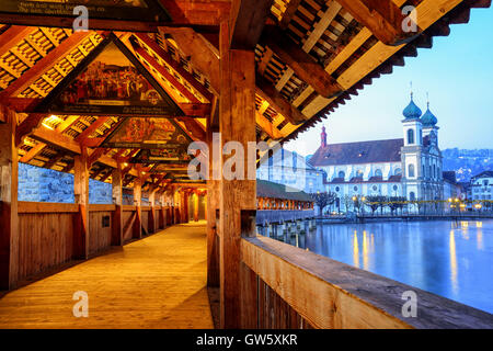 Historical wooden Chapel Bridge decorated with medieval paintings in the old town of Lucerne, Switzerland Stock Photo