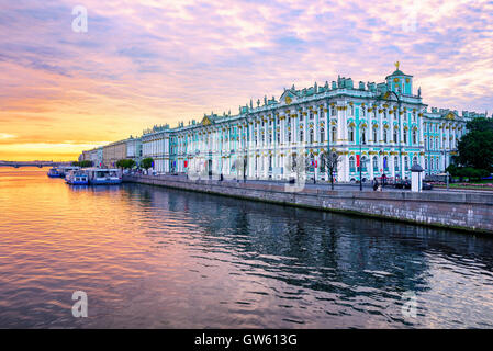 Winter Palace building housing Hermitage museum reflects in Neva river on dramatic sunrise, St Petersburg, Russia Stock Photo