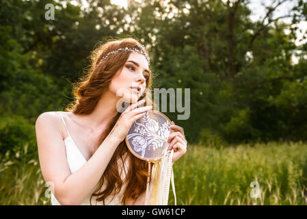 young redheaded girl smiling, Girl holding guardian, beautiful redheaded young girl, Girl holding dreamcatcher Stock Photo