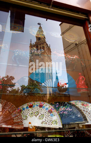 La Giralda, Bell tower of Seville, reflected in shop window with spanish hand fans, abanicos, Andalusia, Spain. Stock Photo