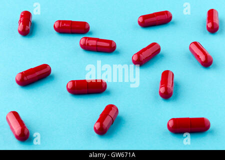 Close up of red pills scattered on the table Stock Photo - Alamy