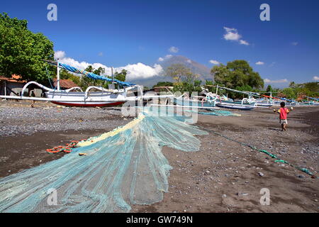 The beach with traditional fishing boat (Jukung) in Amed, Bali, Indonesia, the Mount Agung in the background Stock Photo