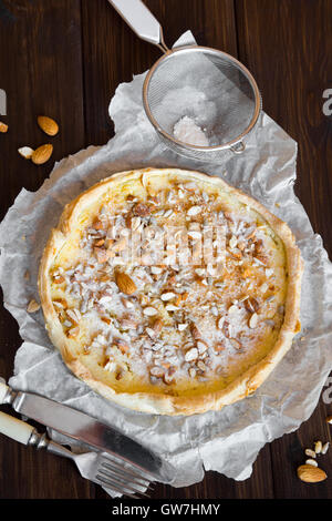 Homemade sweet tart (cheesecake) with cottage cheese, caramel, nuts and seeds Stock Photo