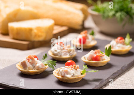 canapes, appetizer with creamy Chicken salad served on a slate plate Stock Photo